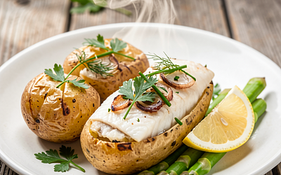 Baked potatoes with cod fillet and herbs (Polish traditional)
