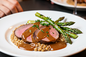 Veal in gravy sauce with spelt and green asparagus