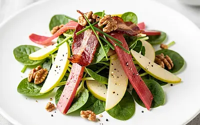 Sorrel with apple and smoked bacon on young lettuce leaves