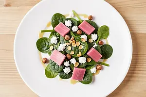 Young spinach with rhubarb, Korycin cheese, and hazelnuts