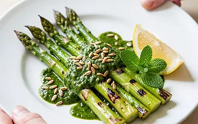 Grilled green asparagus with sorrel sauce and toasted sunflower seeds