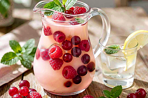 Summer raspberry-currant compote with linden honey and fresh mint