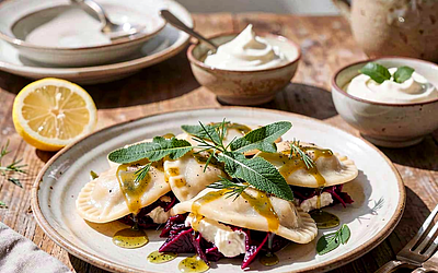 Pierogi with cottage cheese and beet greens, drizzled with sage butter