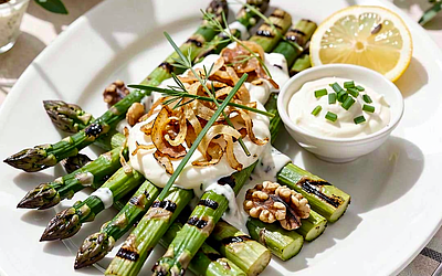 Grilled asparagus with goat cheese sauce, chives, and crispy onion
