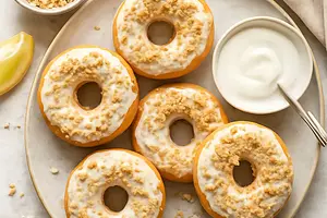 Baked cheese-lemon donuts with yogurt glaze and coconut crumble