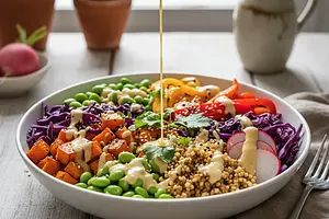 Rainbow Power Bowl with Millet, Roasted Sweet Potatoes, and Tahini-Citrus Sauce