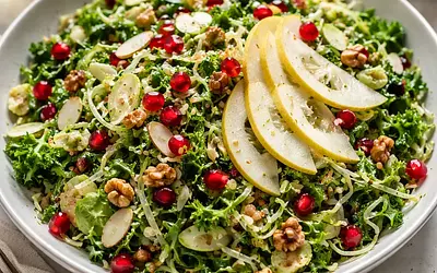 Seasonal salad with thinly sliced Brussels sprouts, kale, and pears with pomegranate and nuts