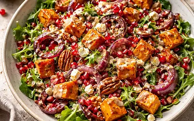 Autumn salad with roasted pumpkin, caramelized onion, pomegranate, and tahini-honey dressing
