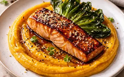 Miso-glazed salmon on kabocha pumpkin puree with crispy pak choi and toasted sesame