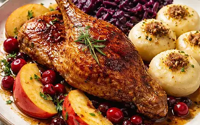 Roast duck in Greater Poland style with apples and cranberries, served with red cabbage and Silesian dumplings