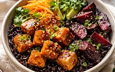 Seasonal Asian-fusion bowl with black rice, glazed tofu, and roasted beets (vegan)