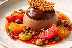 Modern seasonal dessert — Chocolate-chestnut mousse with persimmon, praline, and blood orange sauce