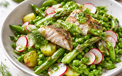 Spring fish salad with young vegetables and dill dressing